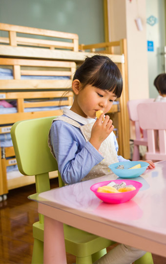 A girl sitting and eating at the table