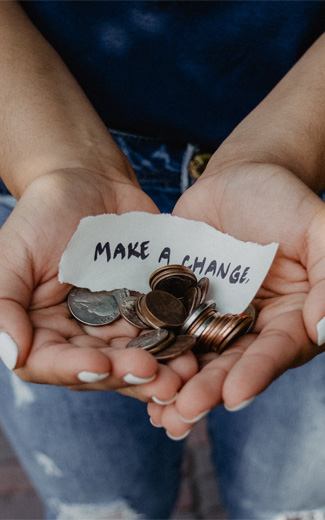 Hand full of change with a note "Make a Change"